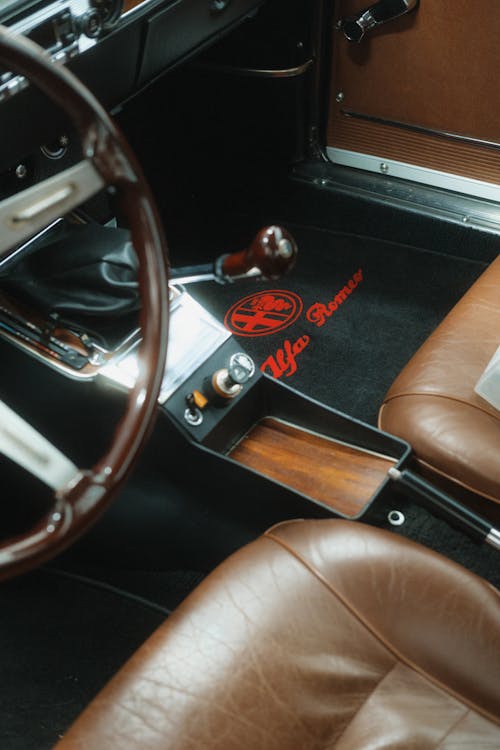 The interior of a car with a steering wheel and dashboard