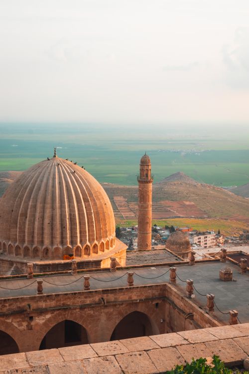 Free A scenic view of a historical dome and minaret with expansive Turkish landscape in the background. Stock Photo