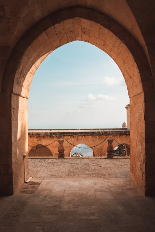 The view from an archway into a room with a view of the ocean