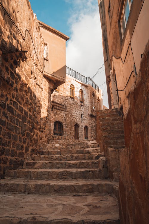 A narrow alley with stone steps leading up to a building