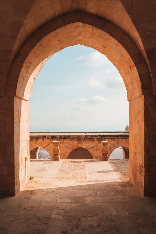 The view from an arched window in a castle