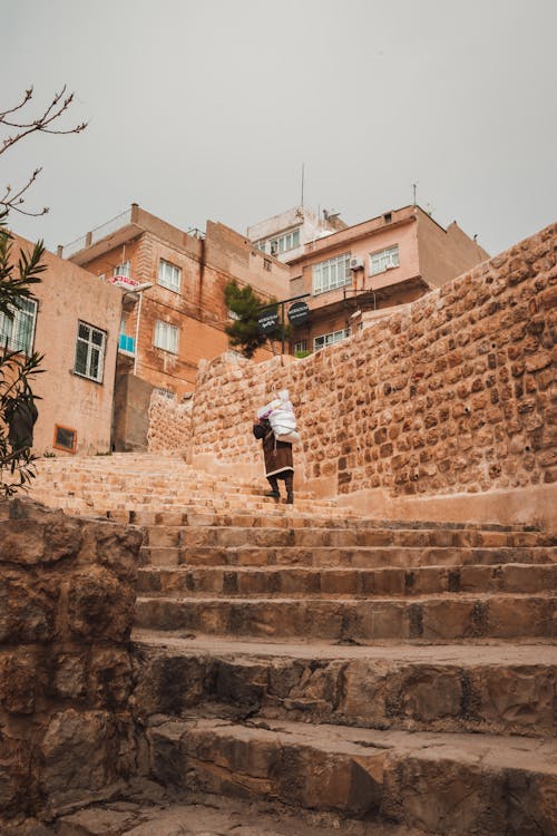 A man walking up some stairs in a city
