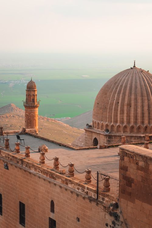 Free Stunning view of a dome and tower overlooking the Mardin landscape at sunset. Stock Photo