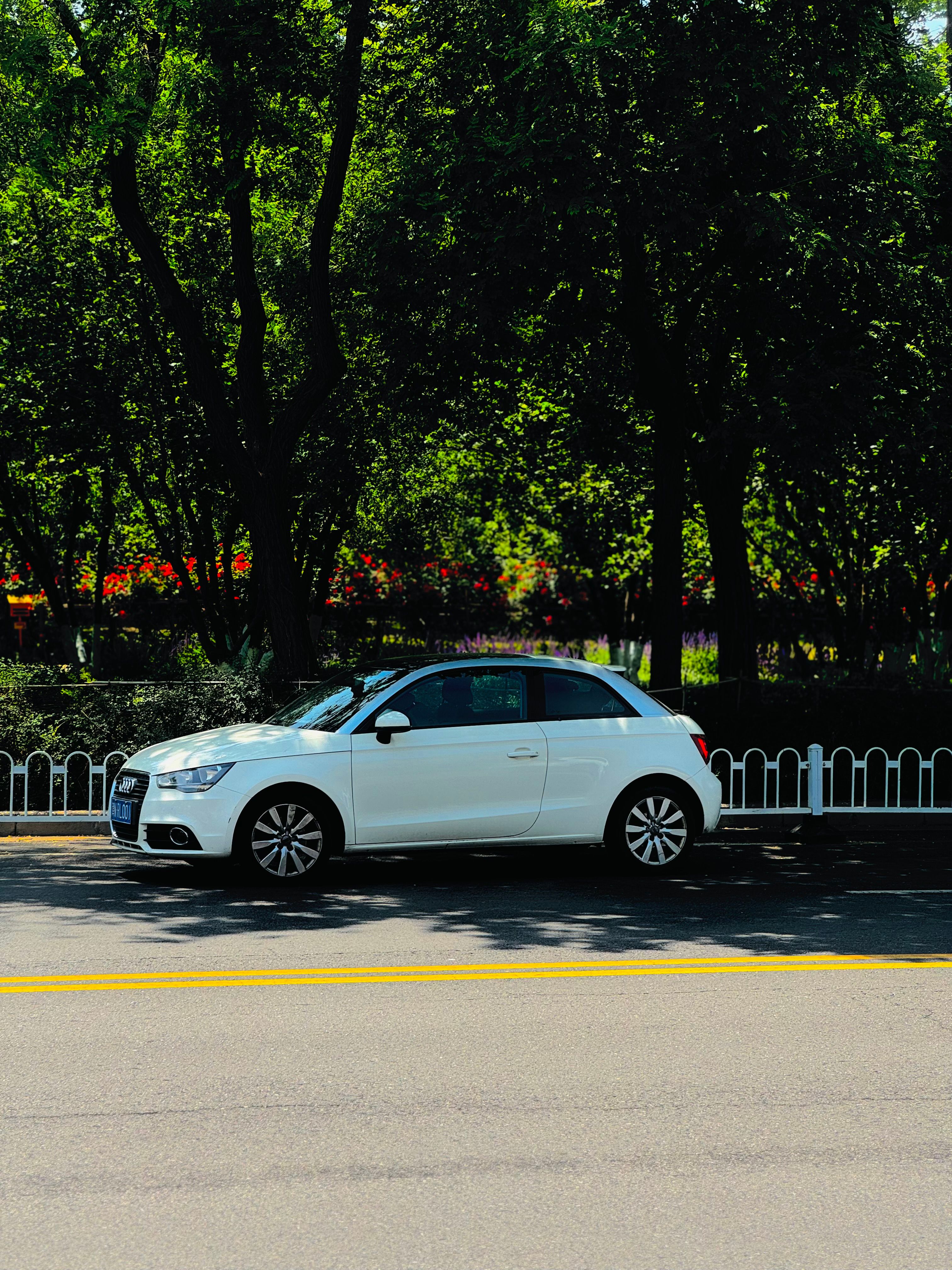 A white car parked on the side of the road · Free Stock Photo