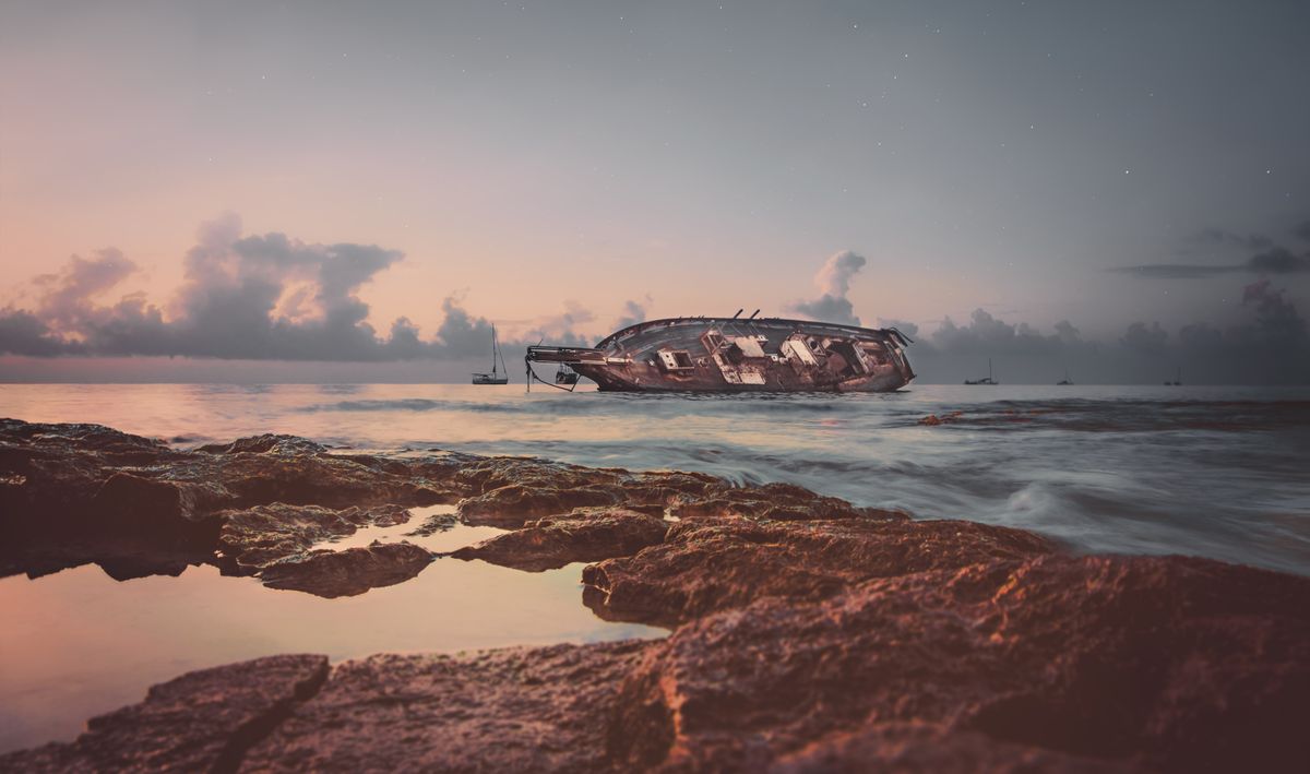 Dramatic view of a shipwreck at sunrise off the coast of Cozumel, Mexico.