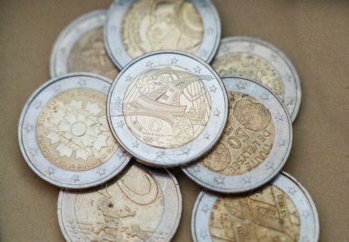 Detailed view of euro coins with a focus on the Eiffel Tower design, symbolizing Paris and France.