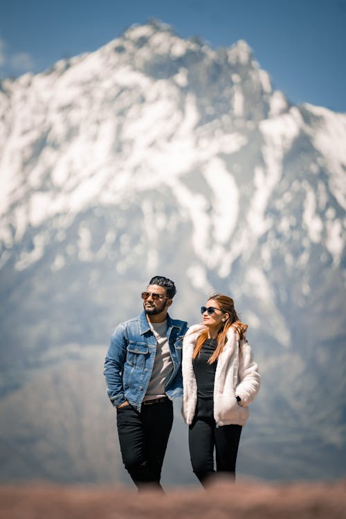 A couple standing in front of a mountain