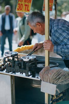 A street vendor in İstanbul selling roasted chestnuts on a sunny day.