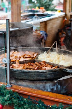 Close-up of traditional street food being cooked outdoors at a market in Poznań, Poland.