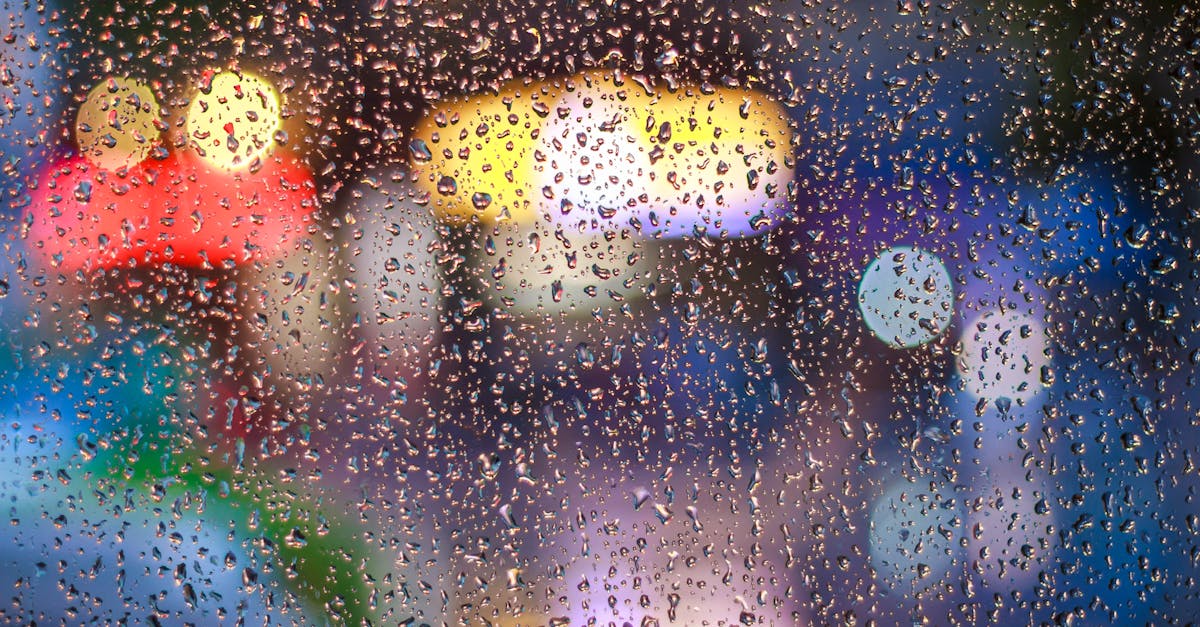Raindrops on a window with vibrant city lights bokeh in Tân Bình, Vietnam.