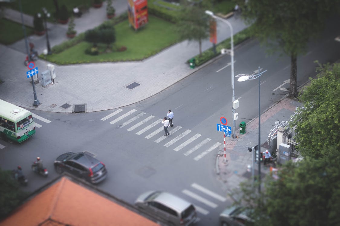 Two Person Walking on Pedestrian Lane