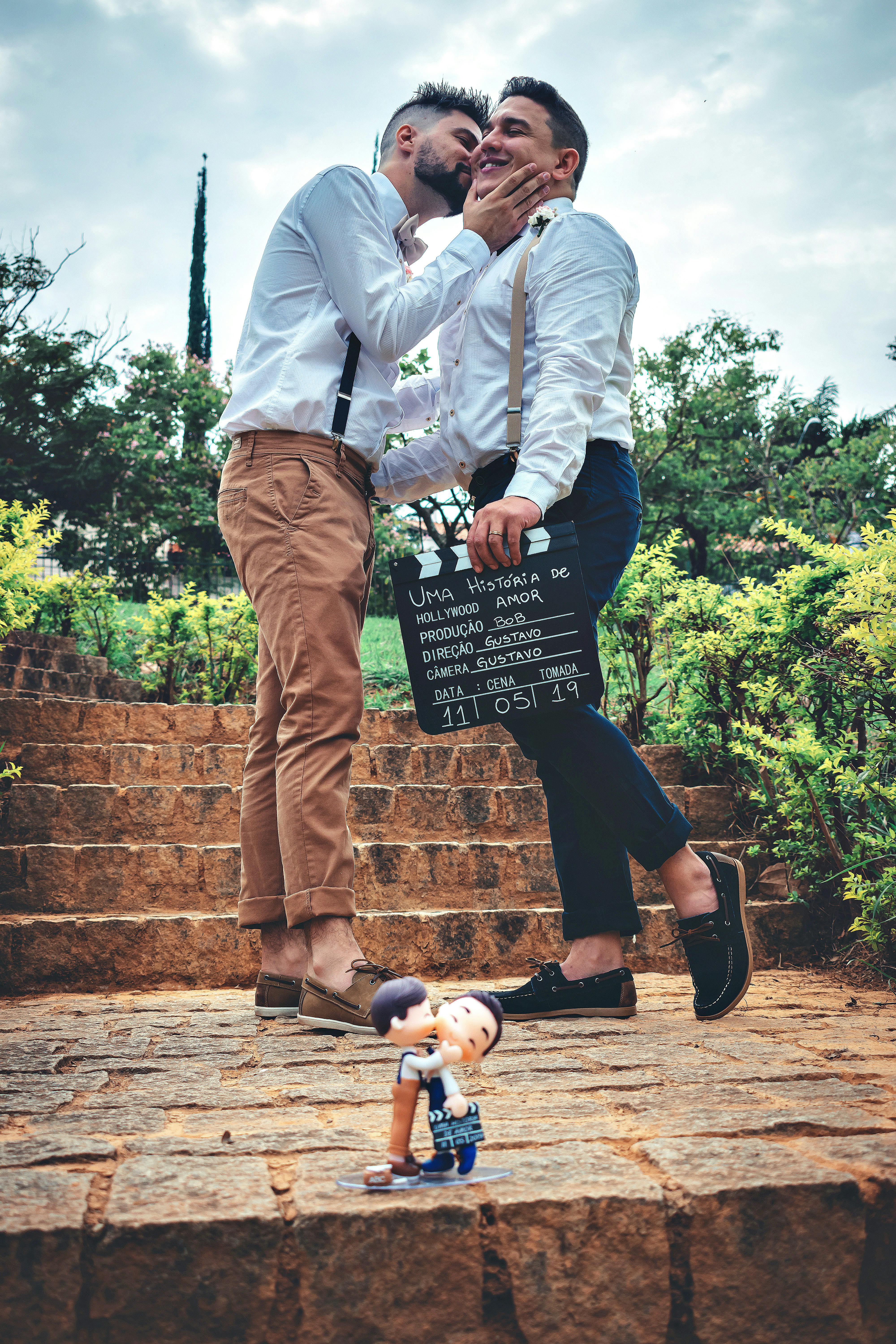 two man kissing on focus photography