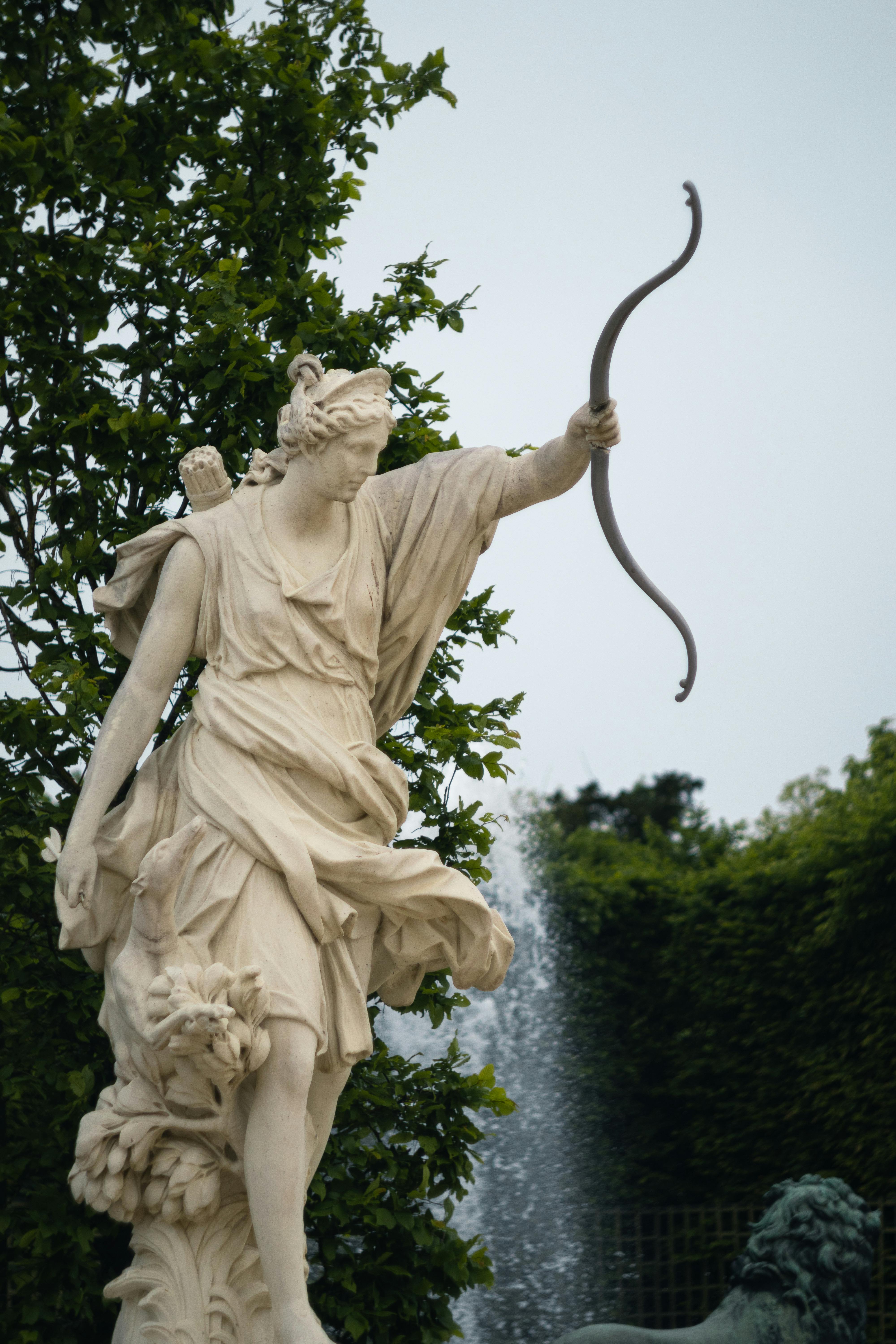 Statue of Diana with a bow in the Palace of Versailles gardens.