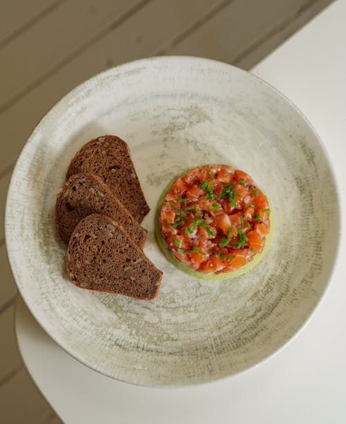 A plate with bread and a bowl of food