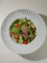 A white plate with a salad on it