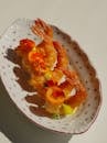 A plate with shrimp and tomatoes on it