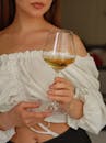 A woman holding a glass of wine in her hand