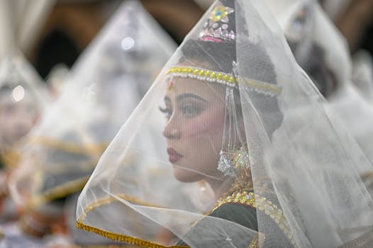 A Manipuri dancer adorned in traditional attire during a cultural performance in Imphal, India.