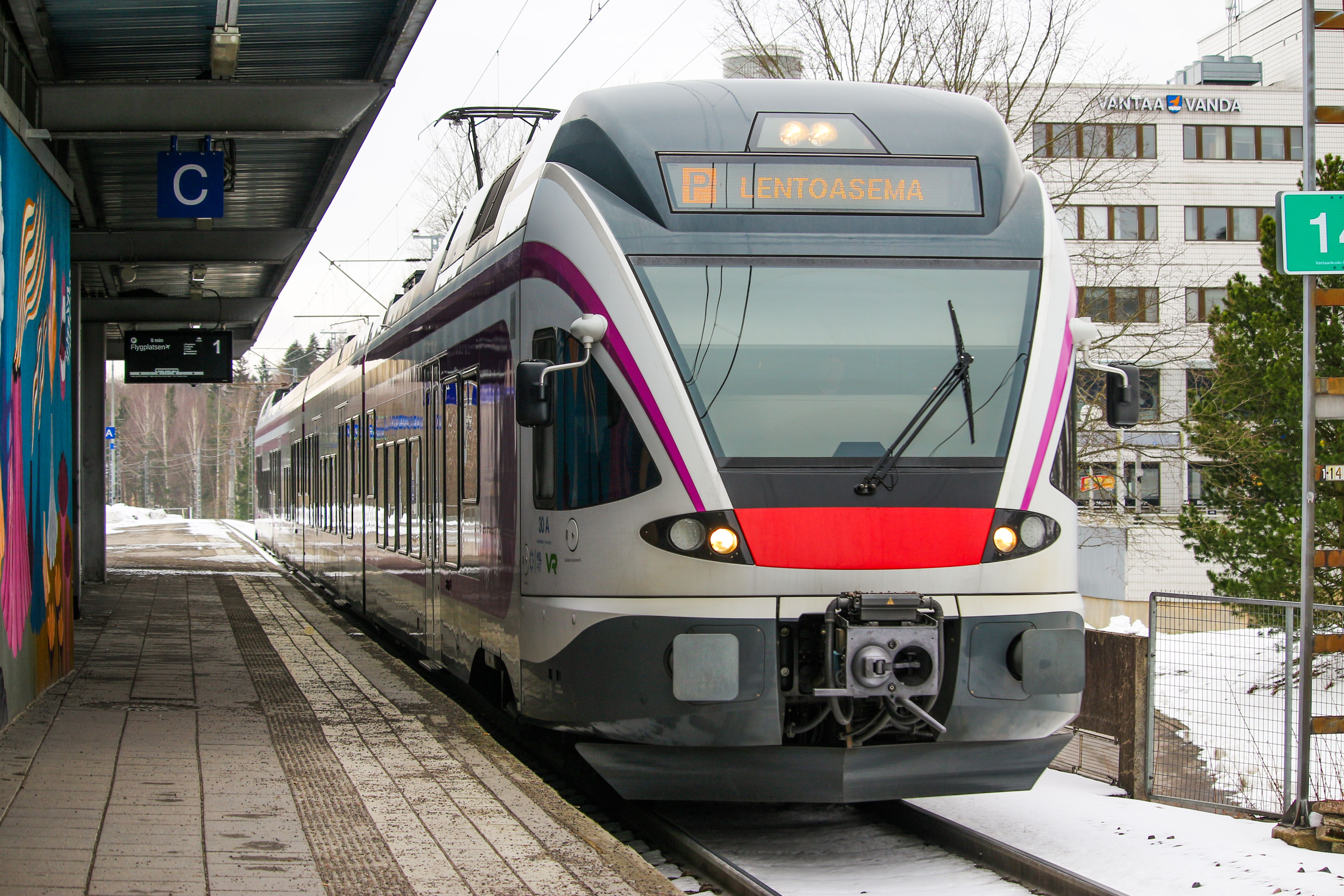 The I or P train of the Ring Rail Line arriving at Helsinki-Vantaa Airport station in Finland, ready for passengers.