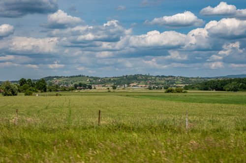 Free Expansive rural fields under a vibrant summer sky in Popovača, Croatia. Stock Photo