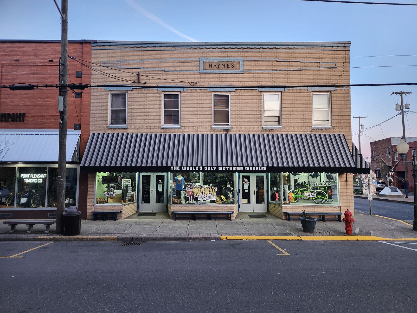 The World's Only Mothman Museum, located in Point Pleasant, WV, at dusk, capturing its unique storefront.