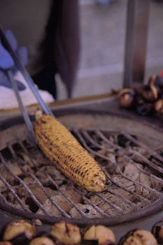 Close-up of corn cob grilling over charcoal in Istanbul, Türkiye.