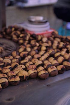 Close-up of roasted chestnuts at an Istanbul street market booth, capturing the essence of Turkish street food.