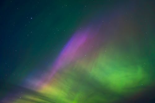 The aurora bore is seen in the sky above a lake