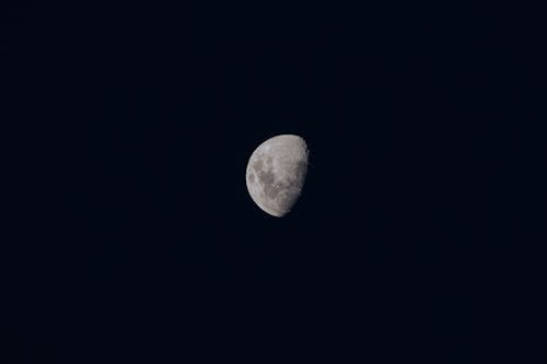 A moon is seen in the dark sky