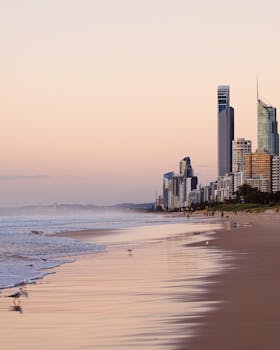 Serene beach view of Surfers Paradise skyline at twilight, Queensland, Australia.