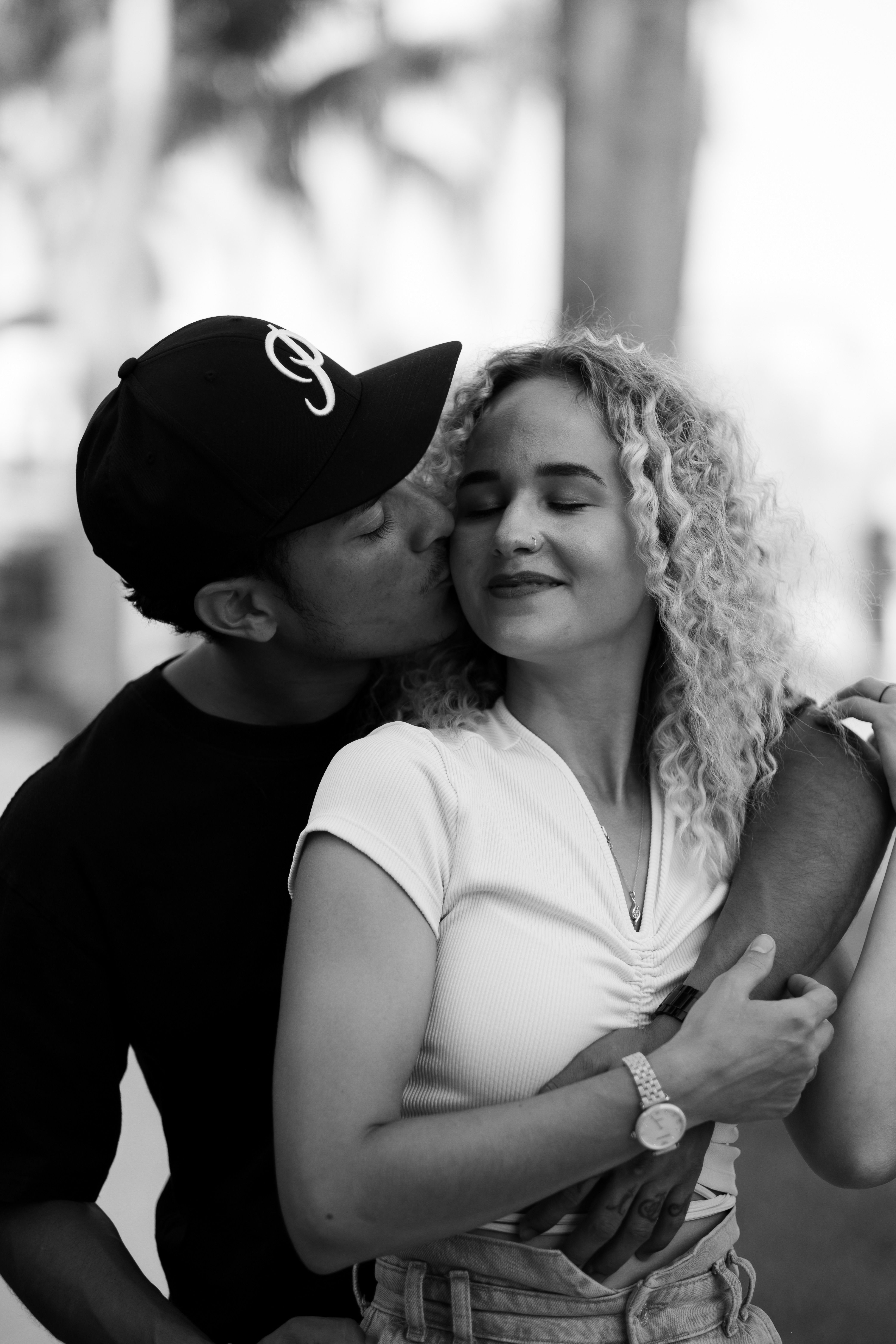 Man Hugging and Kissing a Woman in Black and White · Free Stock Photo