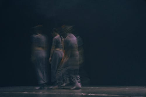 Dancers in a dark room with a blurred background