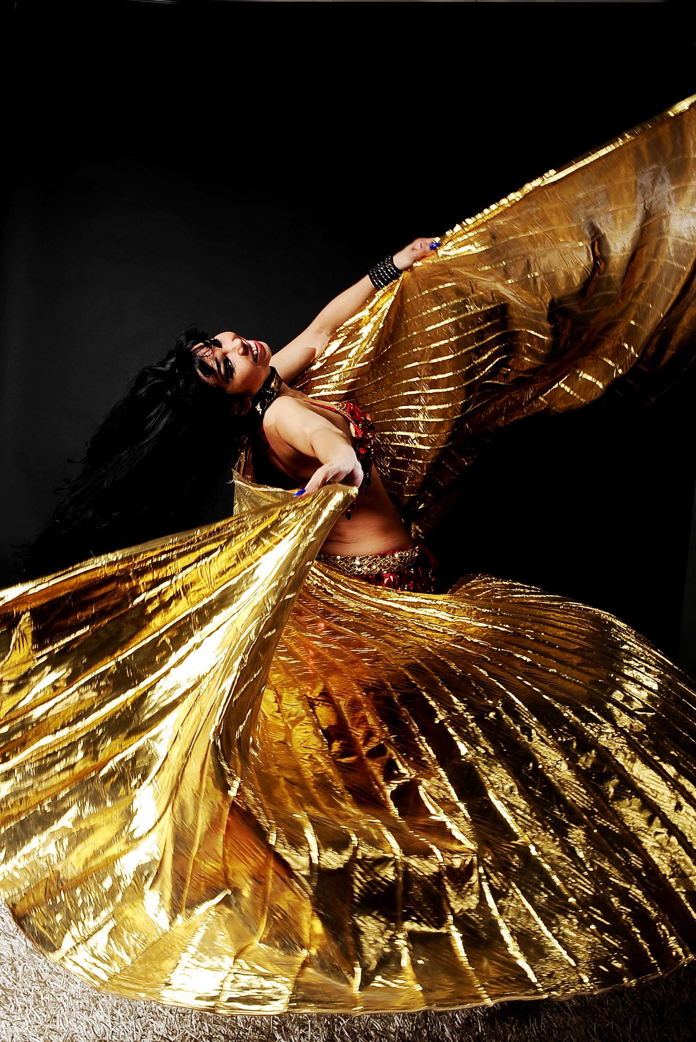 A woman in gold dress with wings · Free Stock Photo