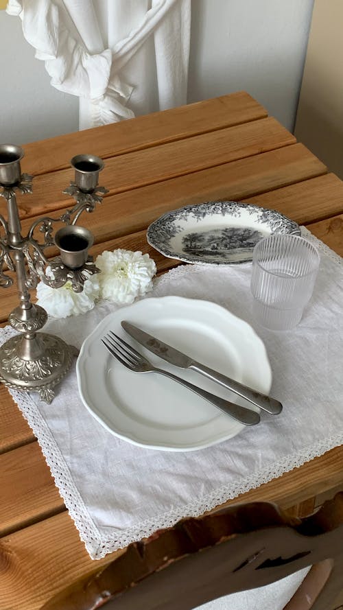 A table with a white tablecloth and silverware