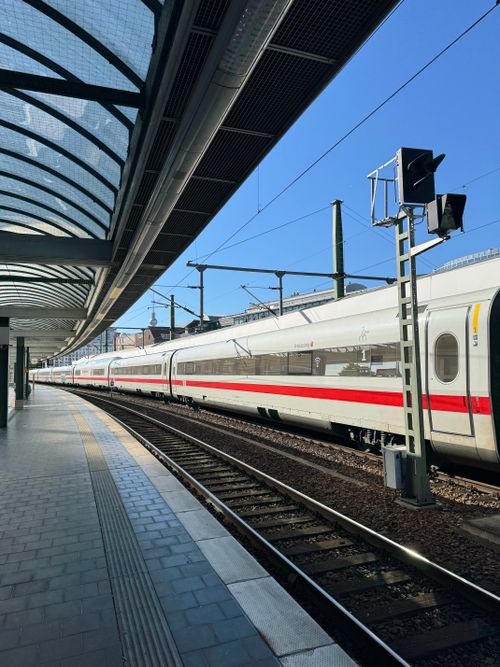 Free High-speed train departing from Berlin station on a sunny day, showcasing modern transportation. Stock Photo