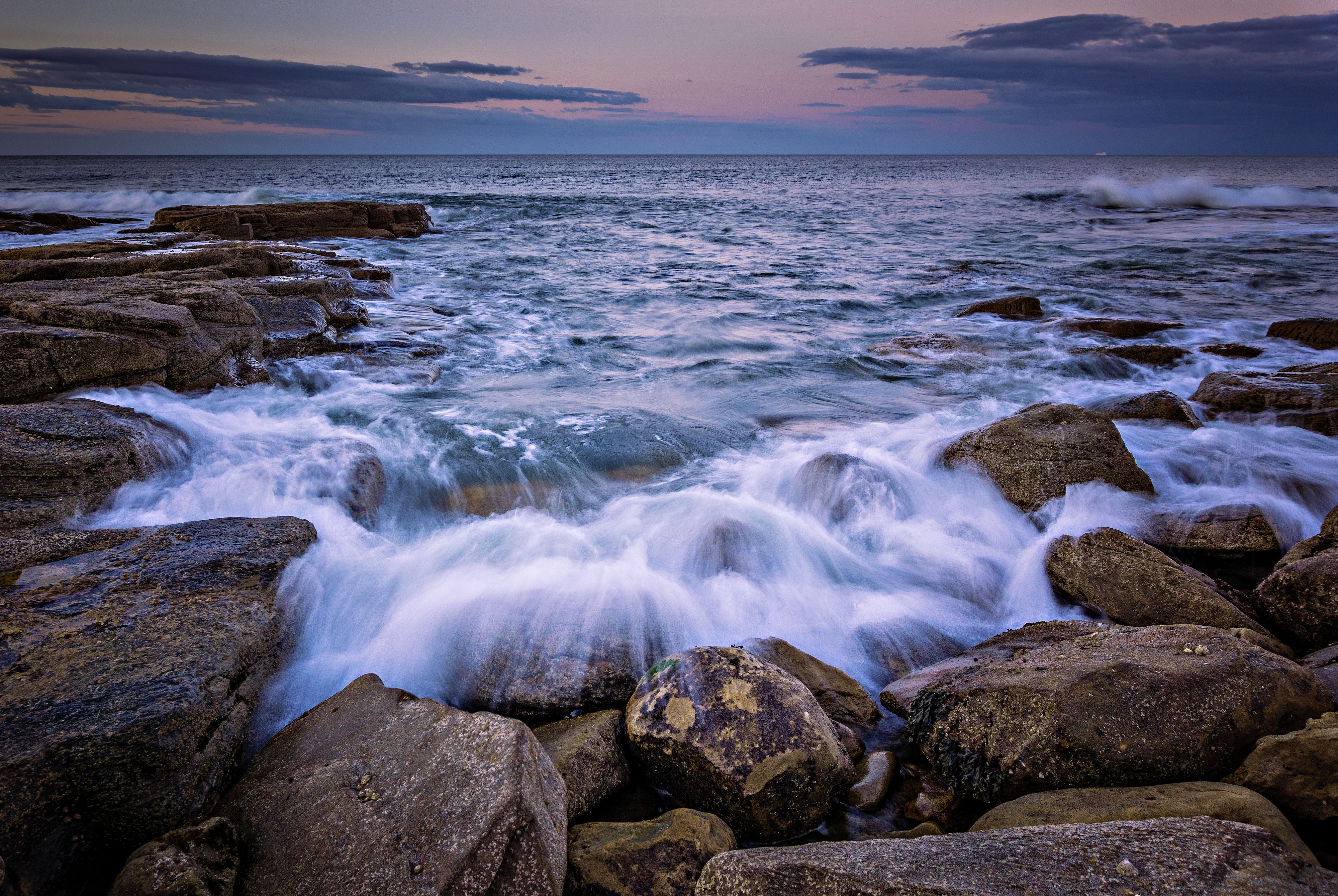 Waves Lapping on Rocks at Dusk · Free Stock Photo