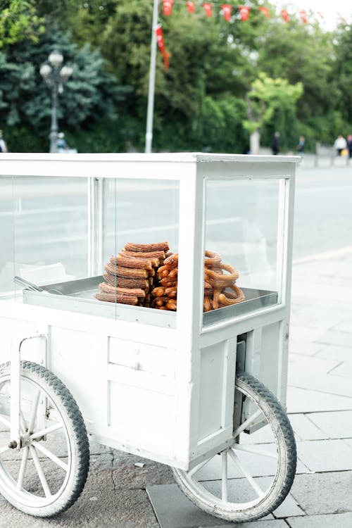 A white cart with donuts on it
