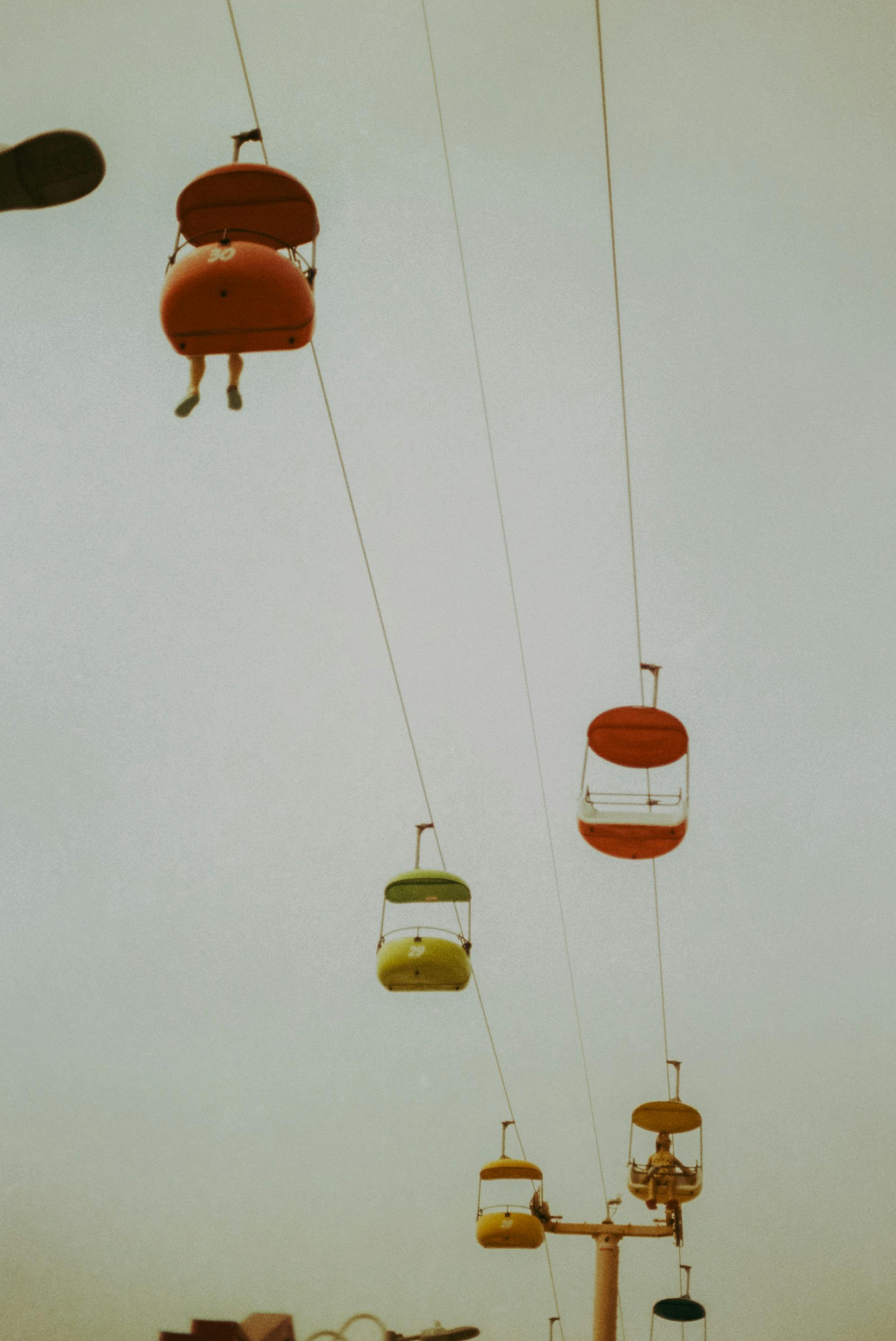 Low angle view of colorful cable cars suspended in the sky, perfect for travel and adventure themes.