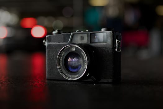 Classic vintage camera on a dark surface with a beautiful bokeh effect in the background.