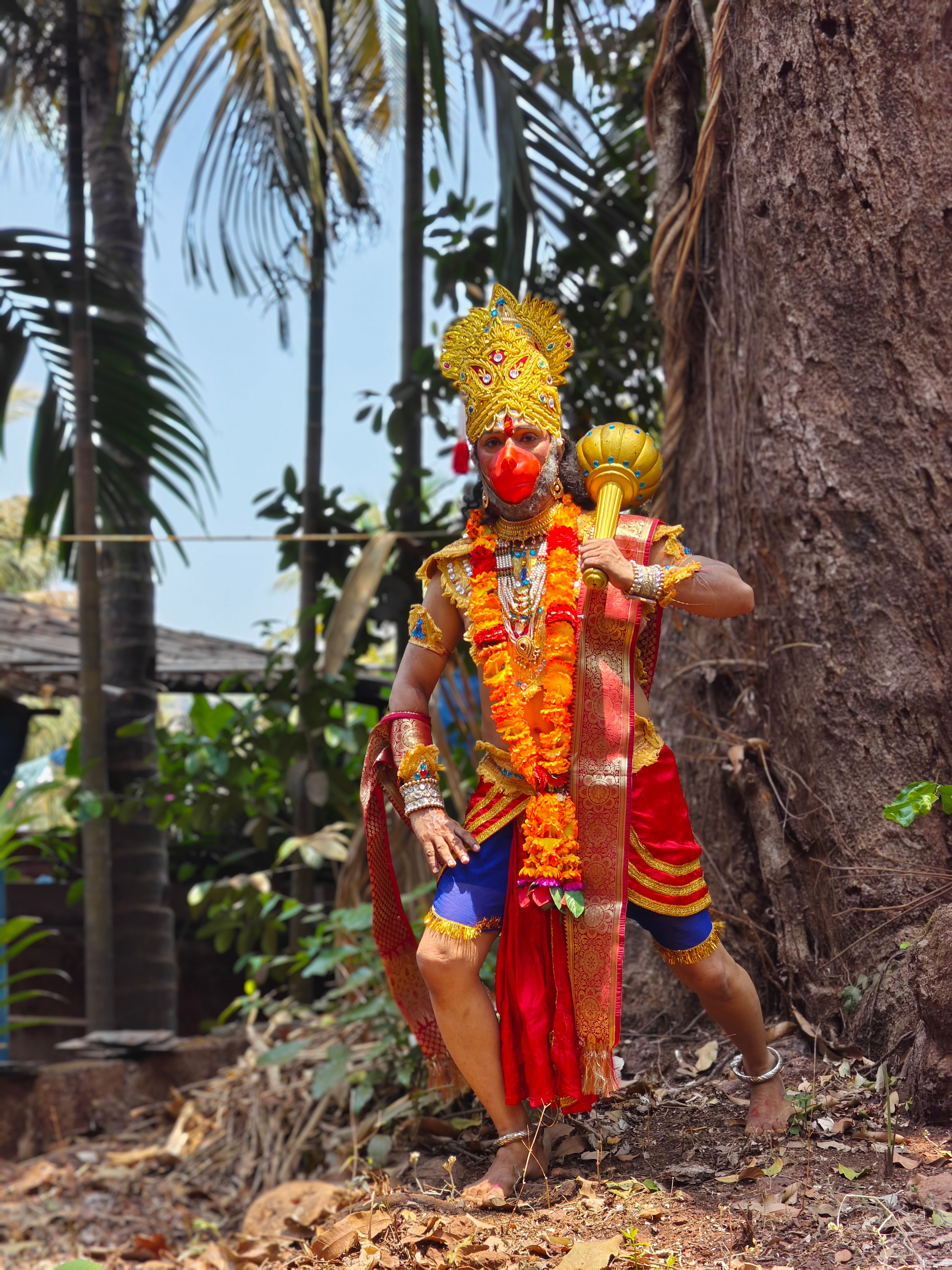Portrait of a person in traditional costume resembling Hanuman, outdoors in Lanja, Maharashtra, India. | Indian Village Development