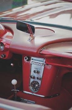 Close-up of a classic red convertible car interior showcasing vintage design.