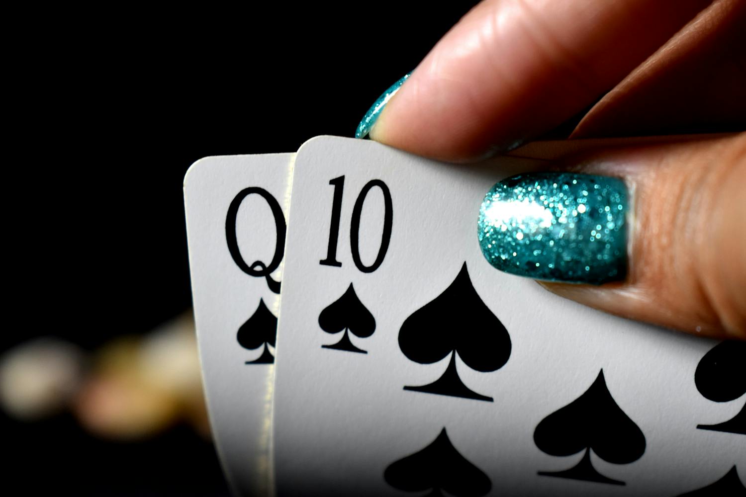 Poker hand with Queen and Ten of spades