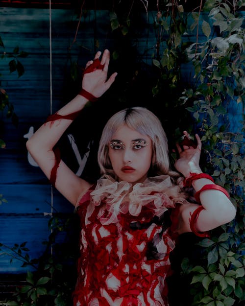 A woman dressed in a zombie costume with blood on her hands
