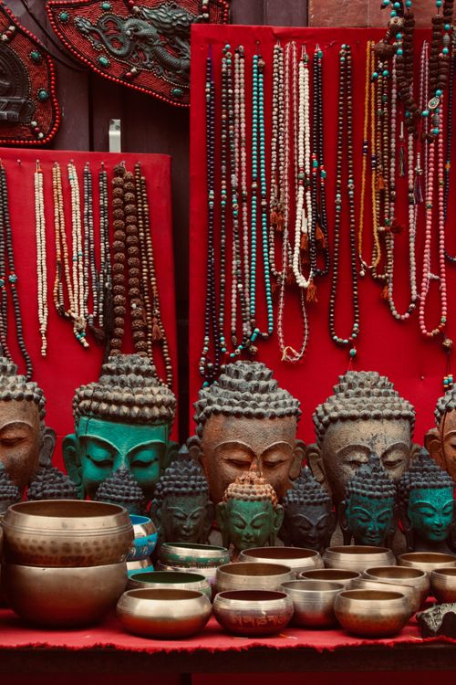 Free Vibrant display of Buddha figurines, beads, and pots at a Kathmandu bazaar. Stock Photo