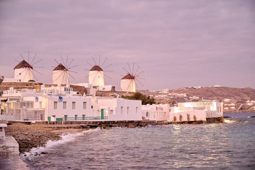 Windmills on the beach in mykonos, greece