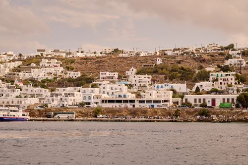 Free Scenic view of Mykonos Island with iconic white architecture nestled on a hill by the sea. Stock Photo