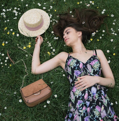Woman Lying On Green Grass Field