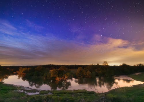A lake and stars under a clear sky