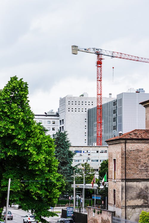 Red Crane Tower Beside White Building