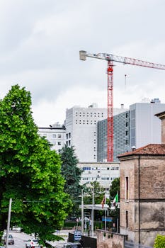 View of construction crane and buildings in Padova, Italy.